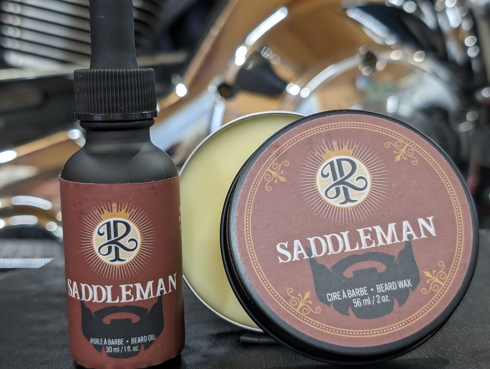 Huile et cire à barbe Saddleman posées devant une moto chromée